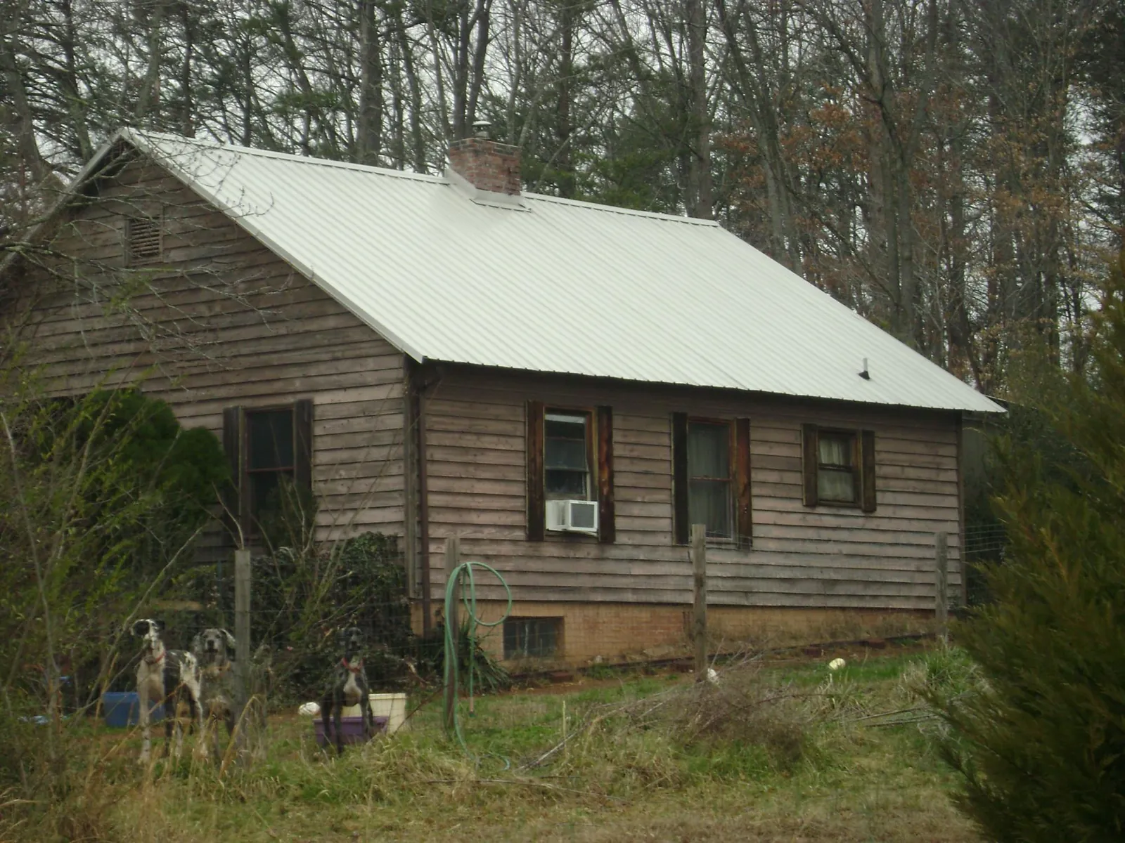White metal roof on an old wood sided farmhouse, from a Metal Roof Installation job in Fitchburg